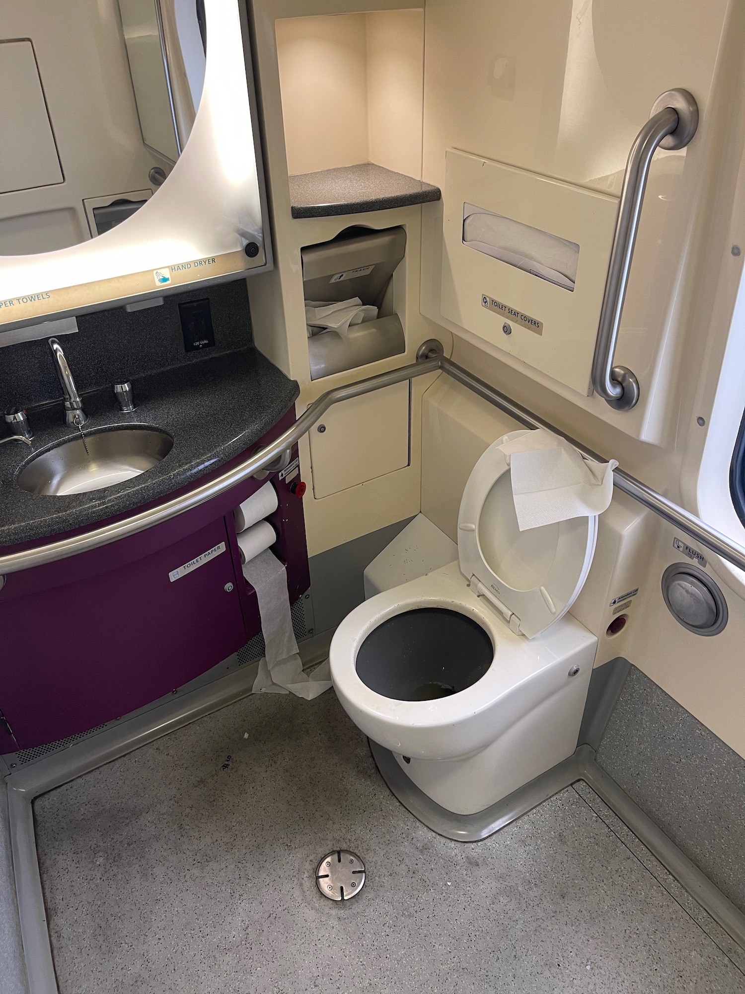 a toilet and sink in a train