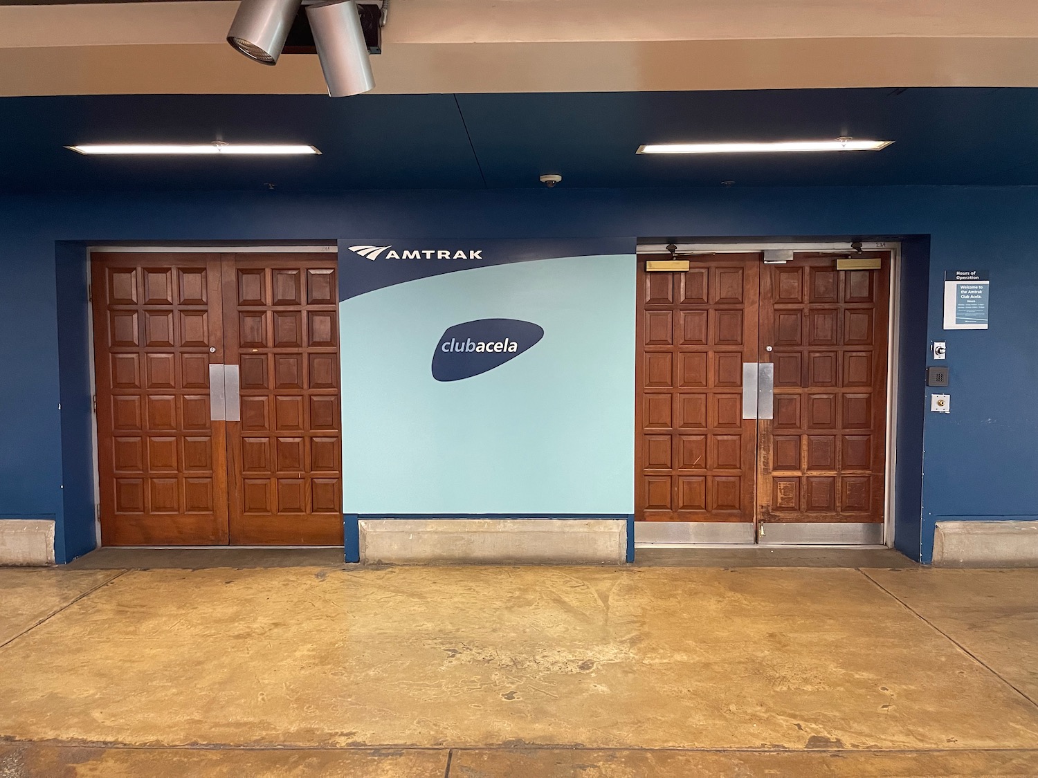 a wall with doors and a logo on it