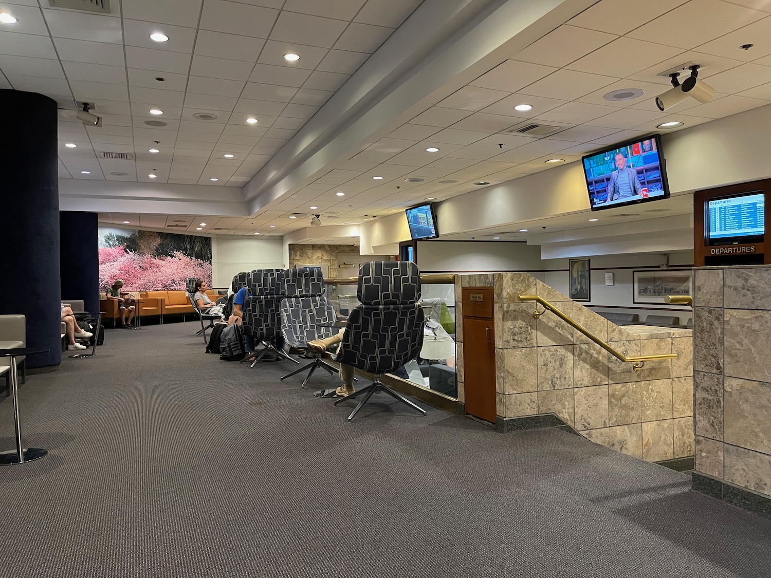 a group of people sitting in chairs in a lobby