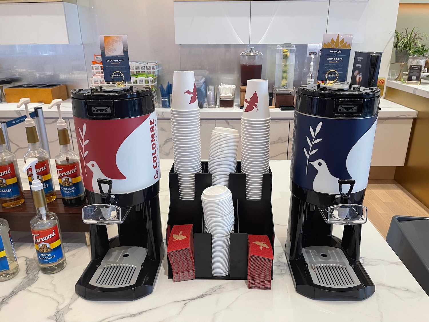 a coffee machine and cups on a counter