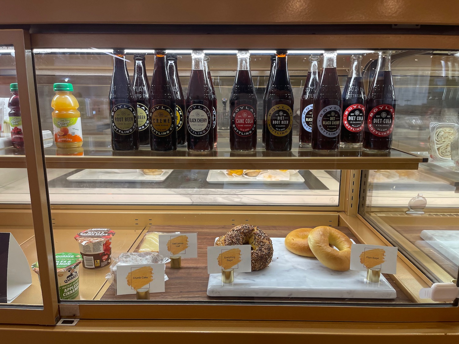 a display case with bottles of beverage and food