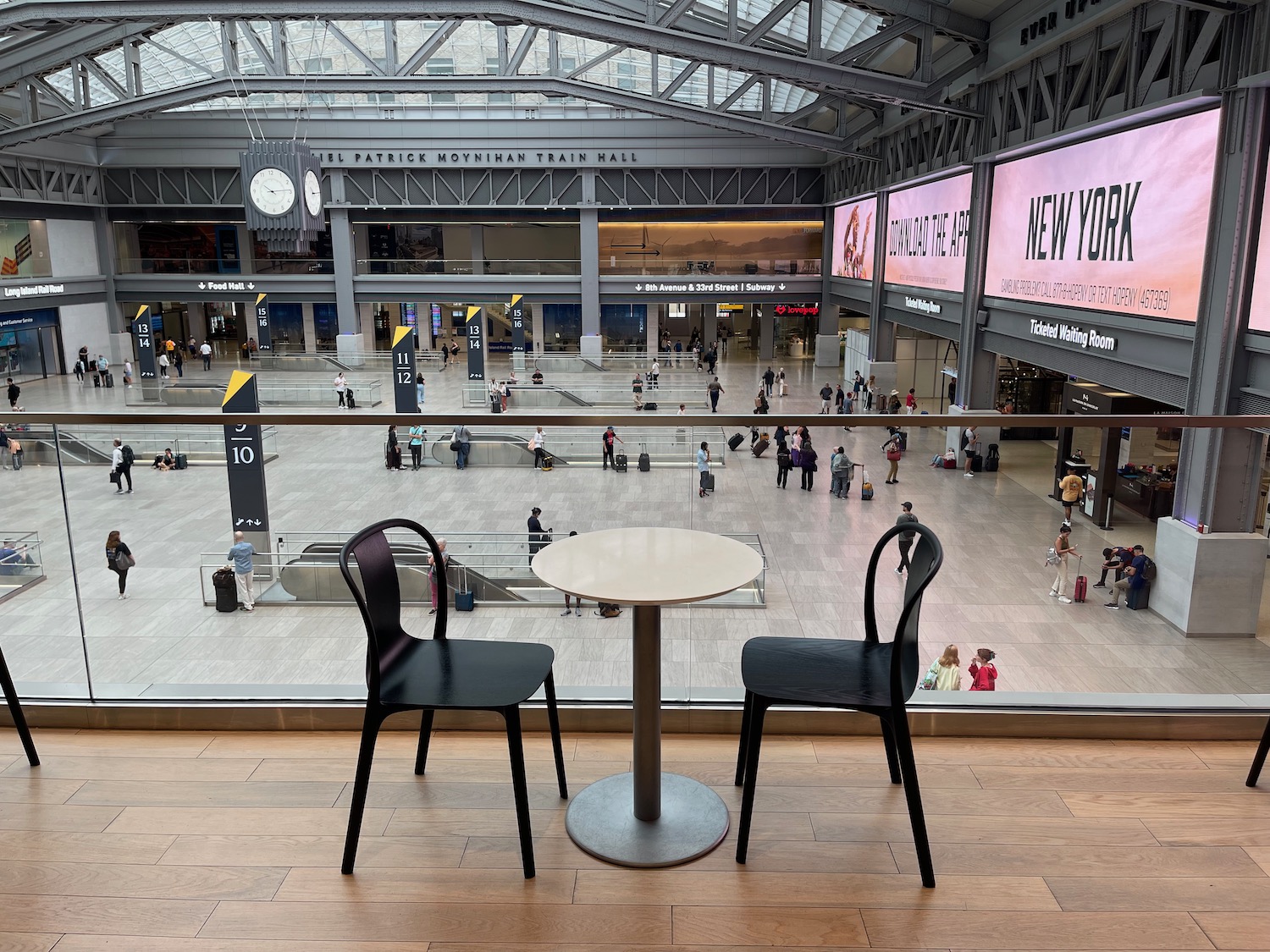 a table and chairs in a large room with people in the background