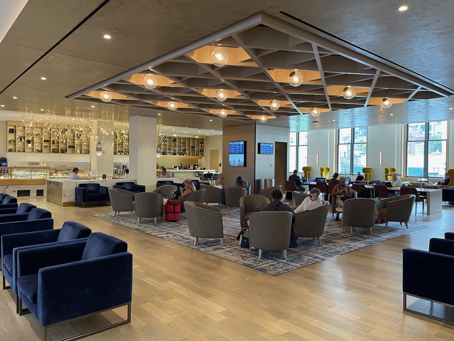 a room with a large ceiling and a group of people sitting in chairs