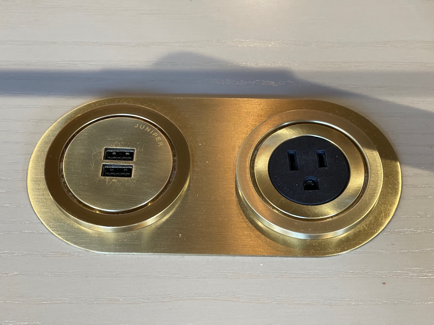 a gold plate with two plugs
