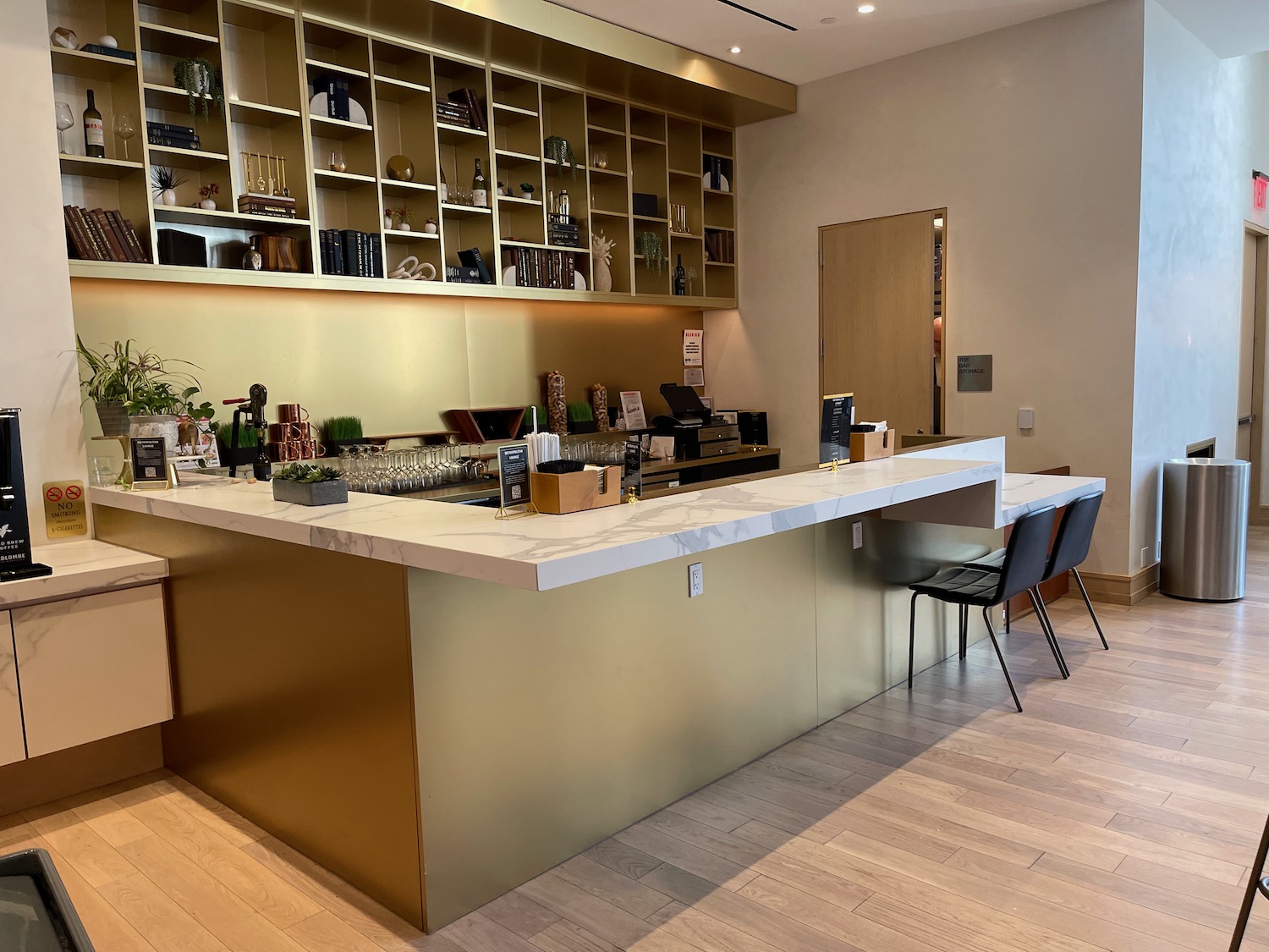 a bar with shelves and chairs