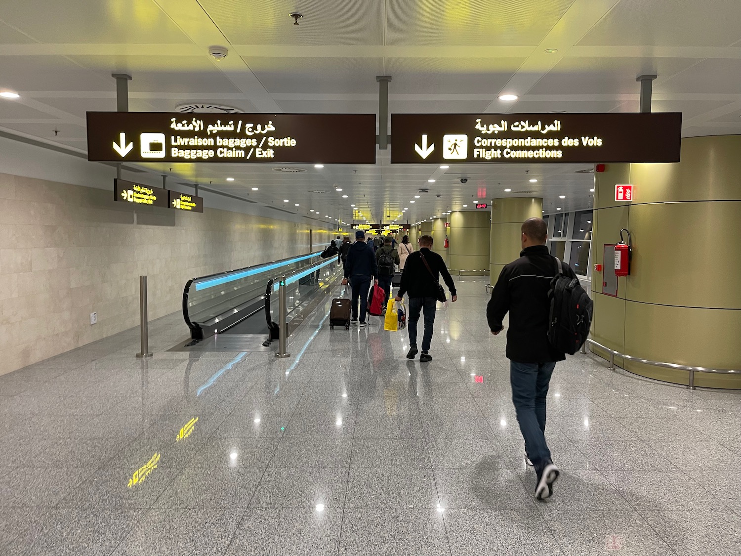 people walking in a building with signs and people