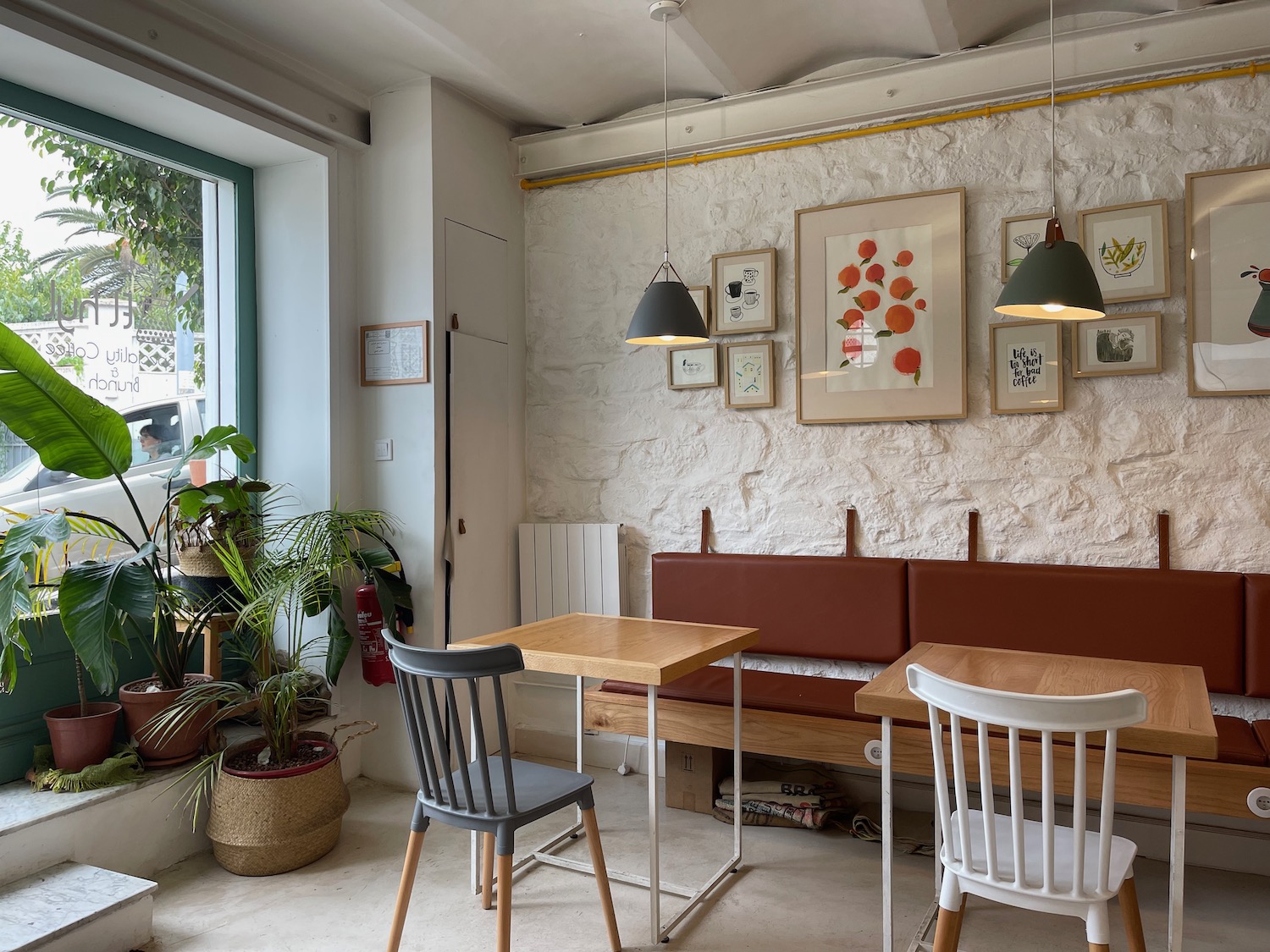 a room with a booth and tables and plants