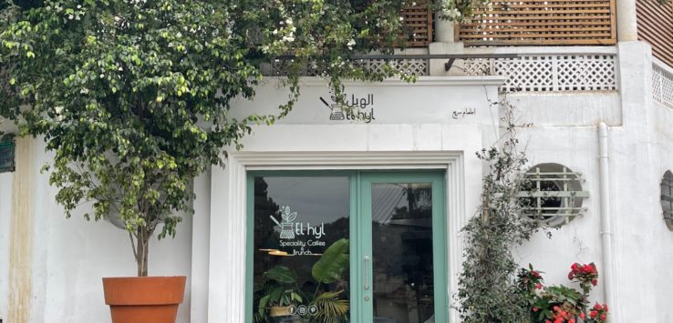 a building with a green door and a bench