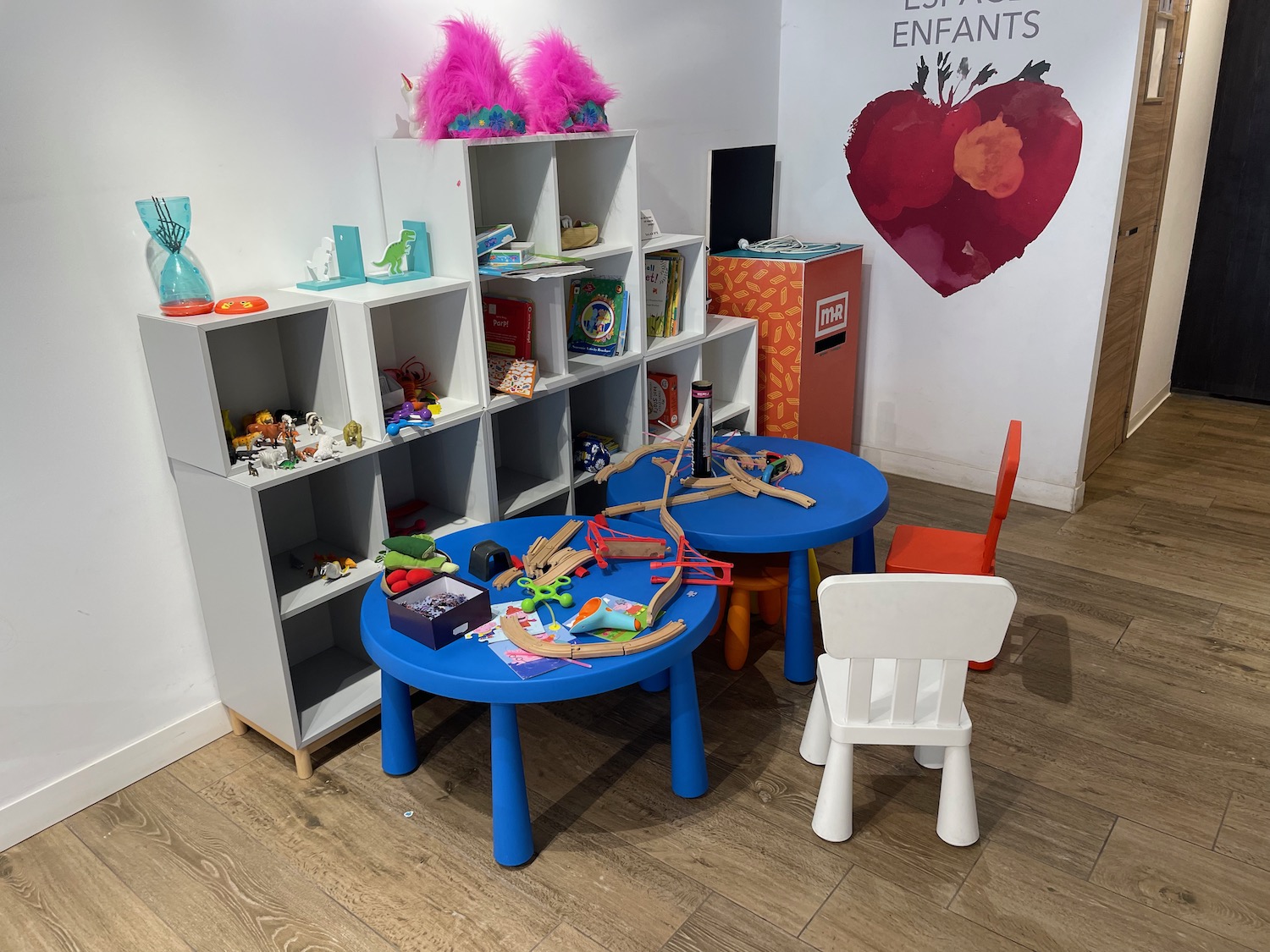 a room with a table and chairs and toys