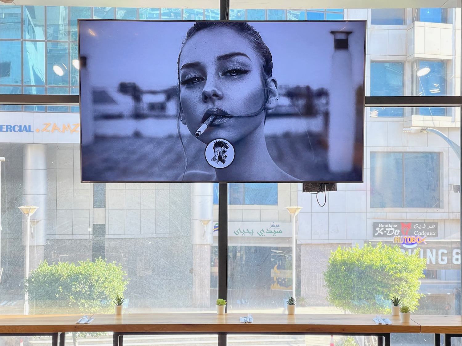 a screen with a picture of a woman smoking a cigarette