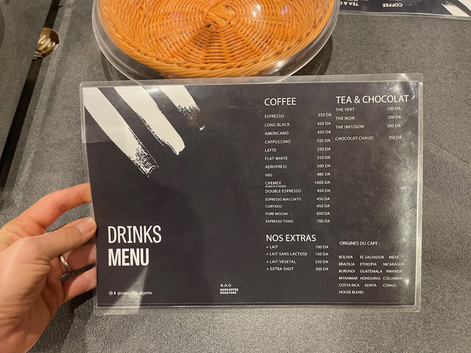 a hand holding a menu