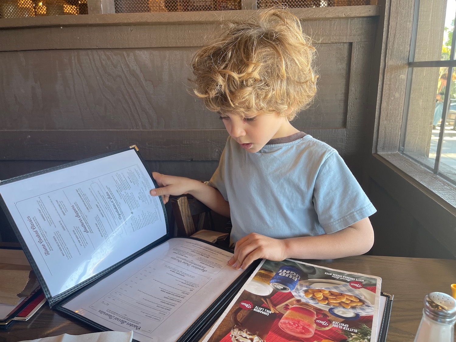 a child looking at a menu