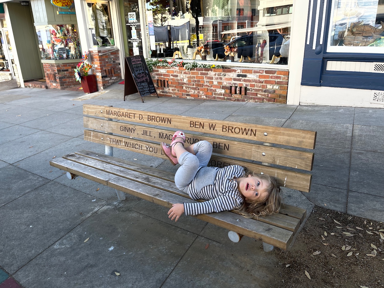 a girl lying on a bench