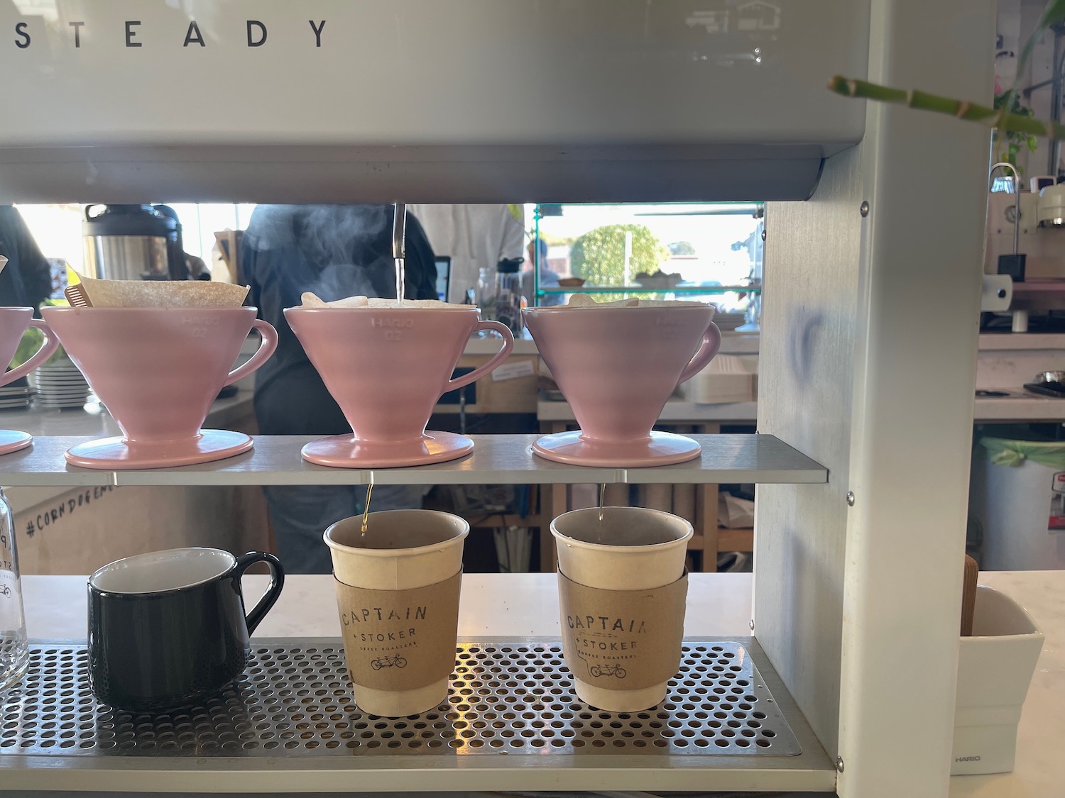 a group of pink cups on a shelf