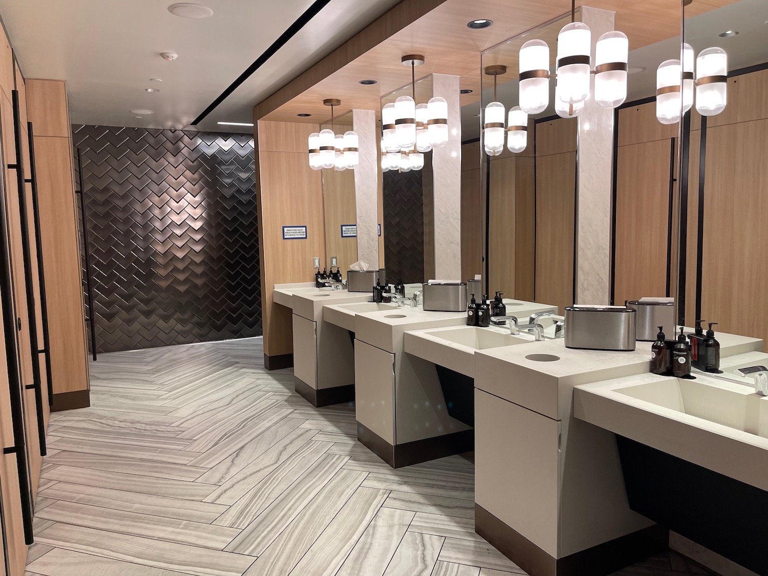 a bathroom with sinks and lights