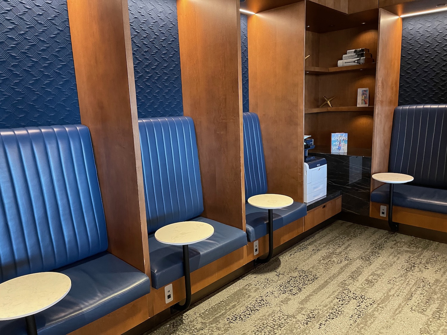 a room with blue seats and shelves