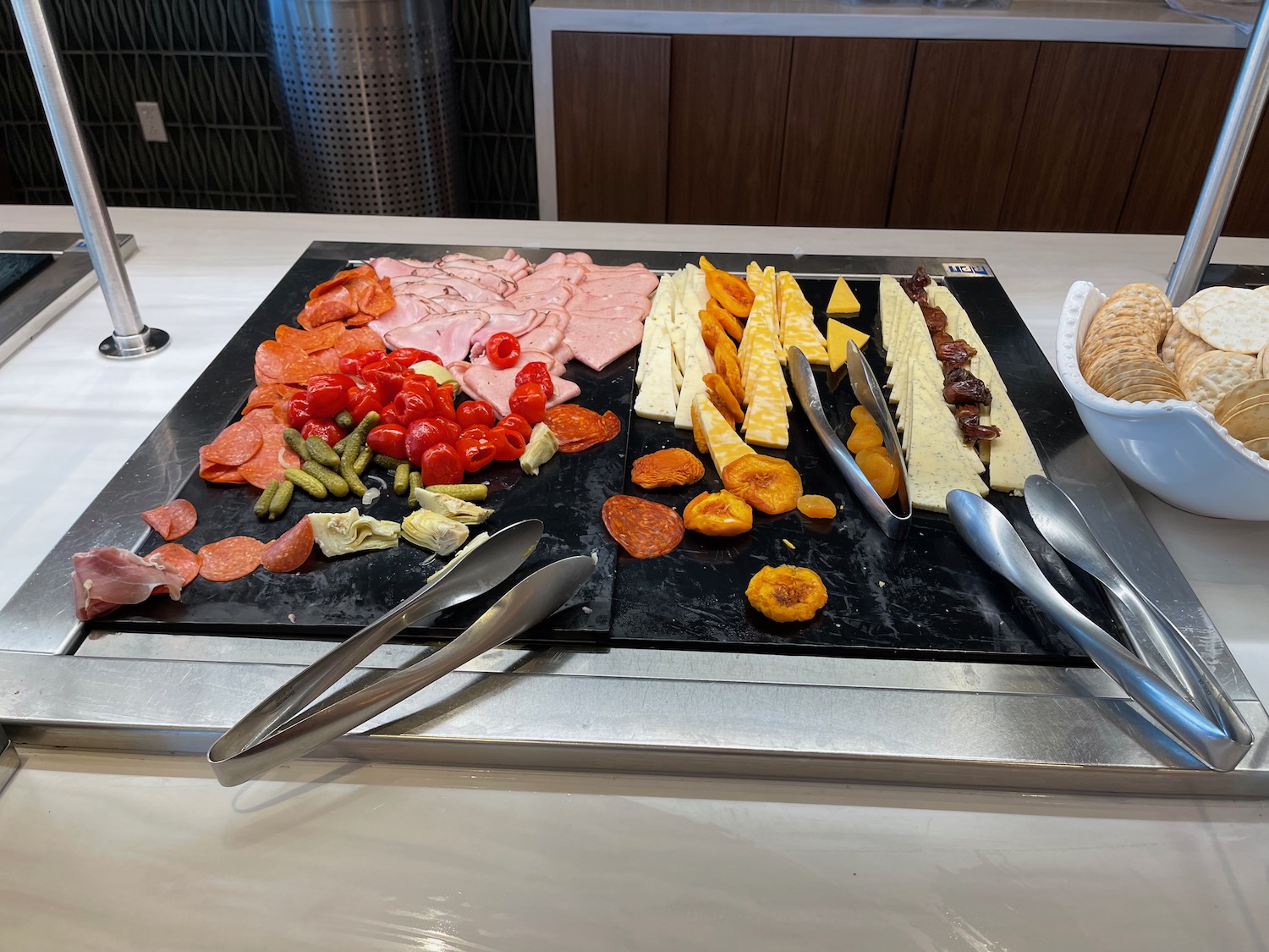 a tray of food with utensils and a bowl of bread