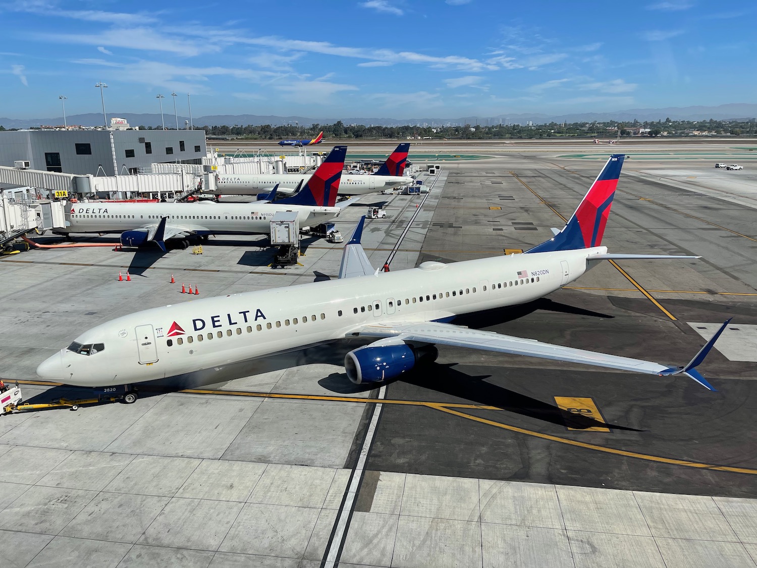 a group of airplanes parked at an airport