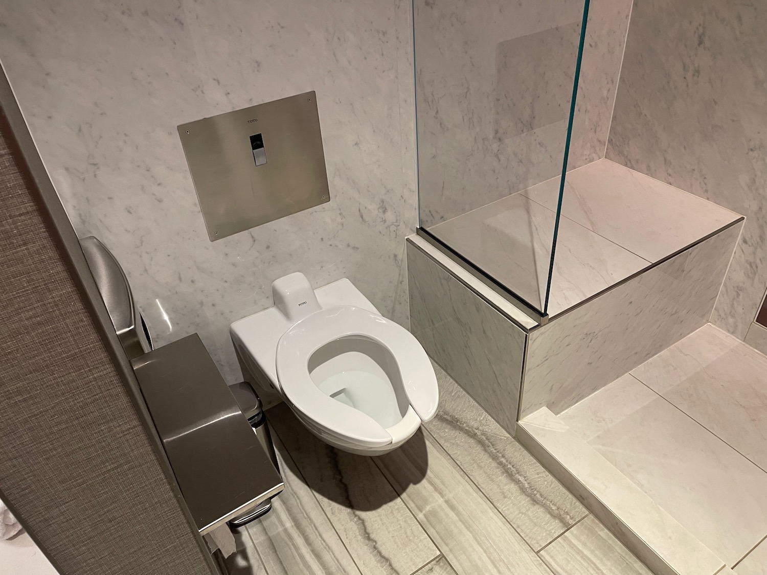 a bathroom with a toilet and shower