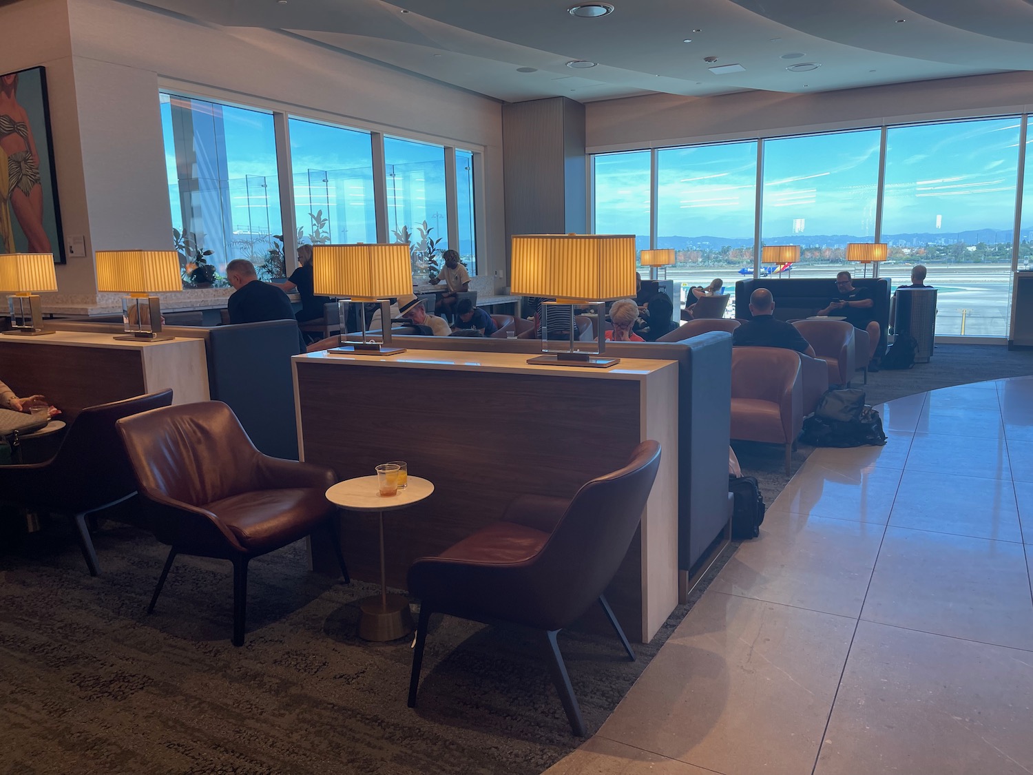 a room with a large window and a group of people sitting in chairs