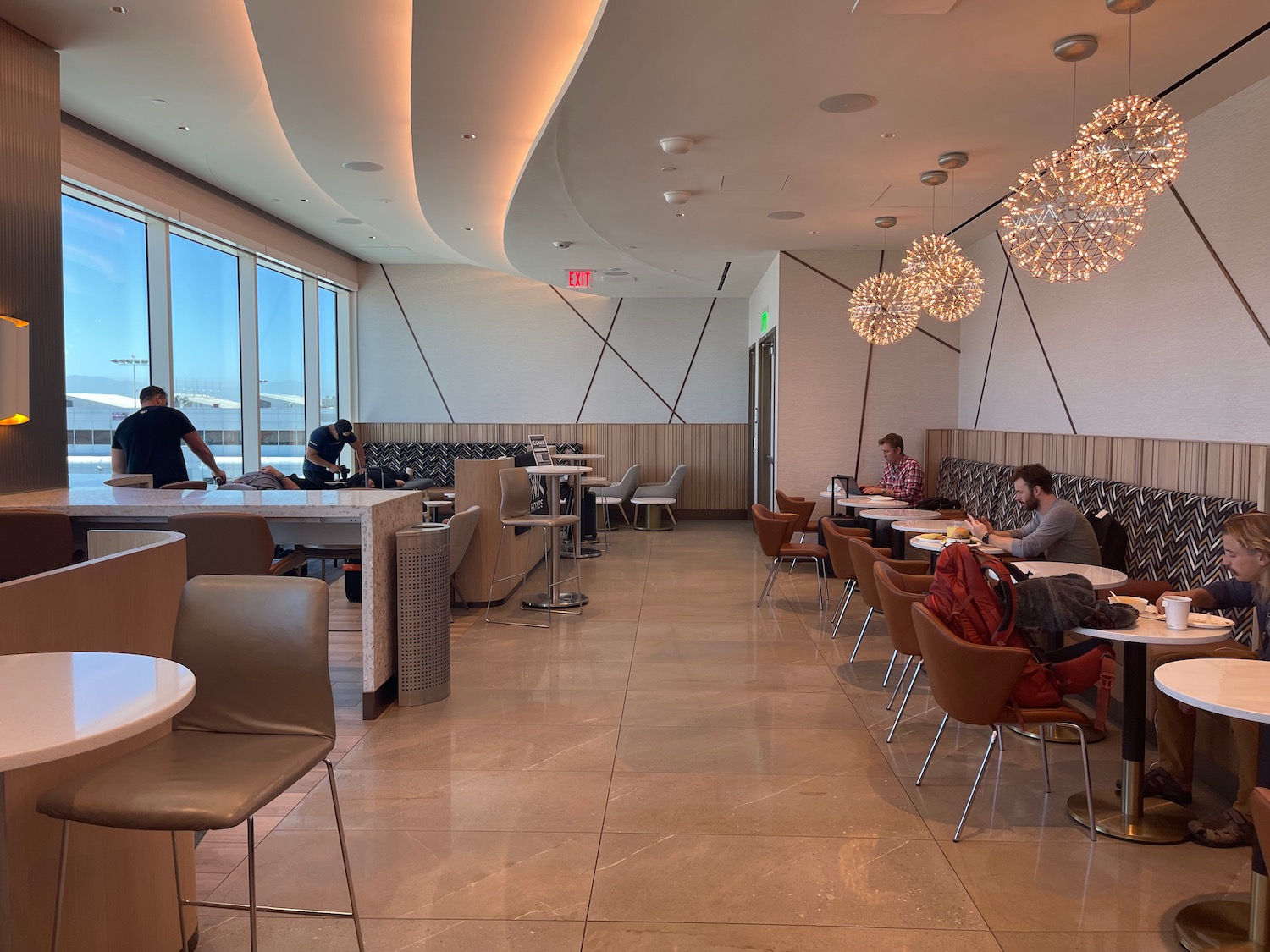 a group of people sitting at tables in a restaurant