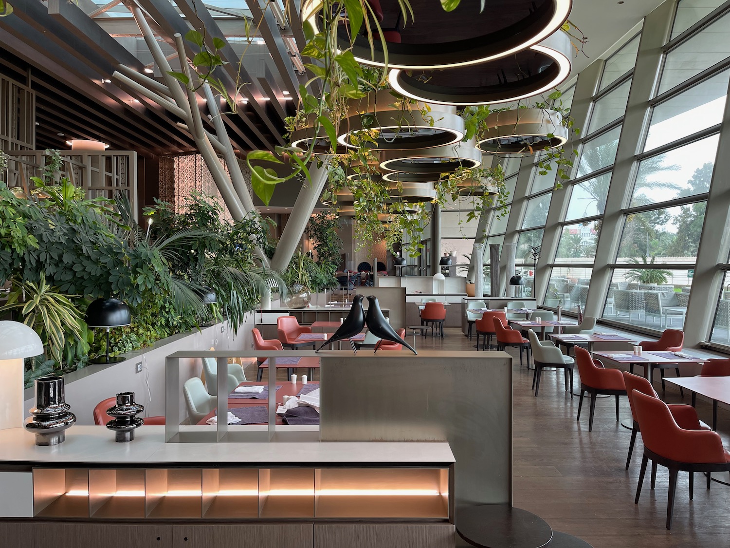 a room with tables and chairs and plants