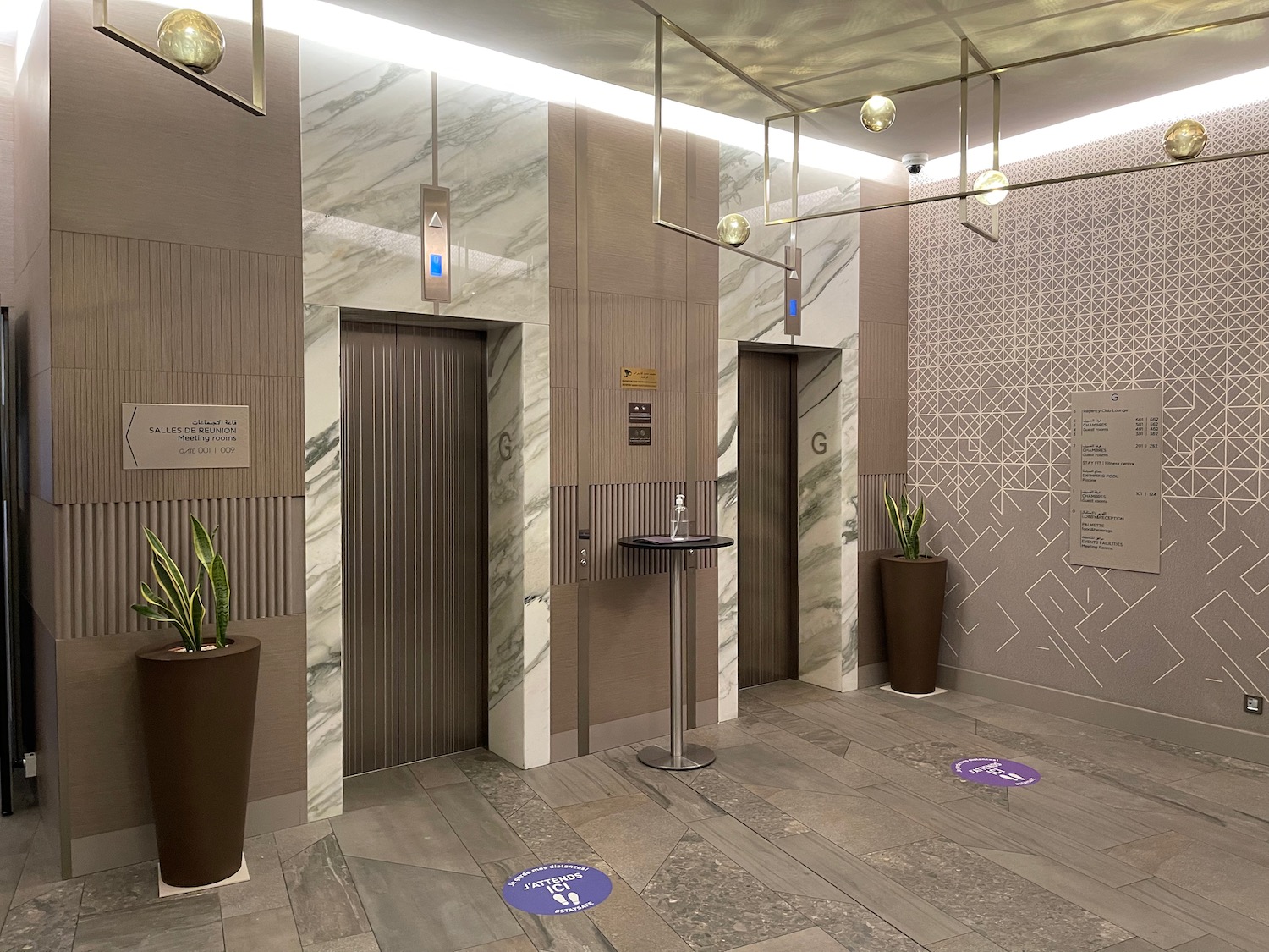 a room with elevator doors and plants