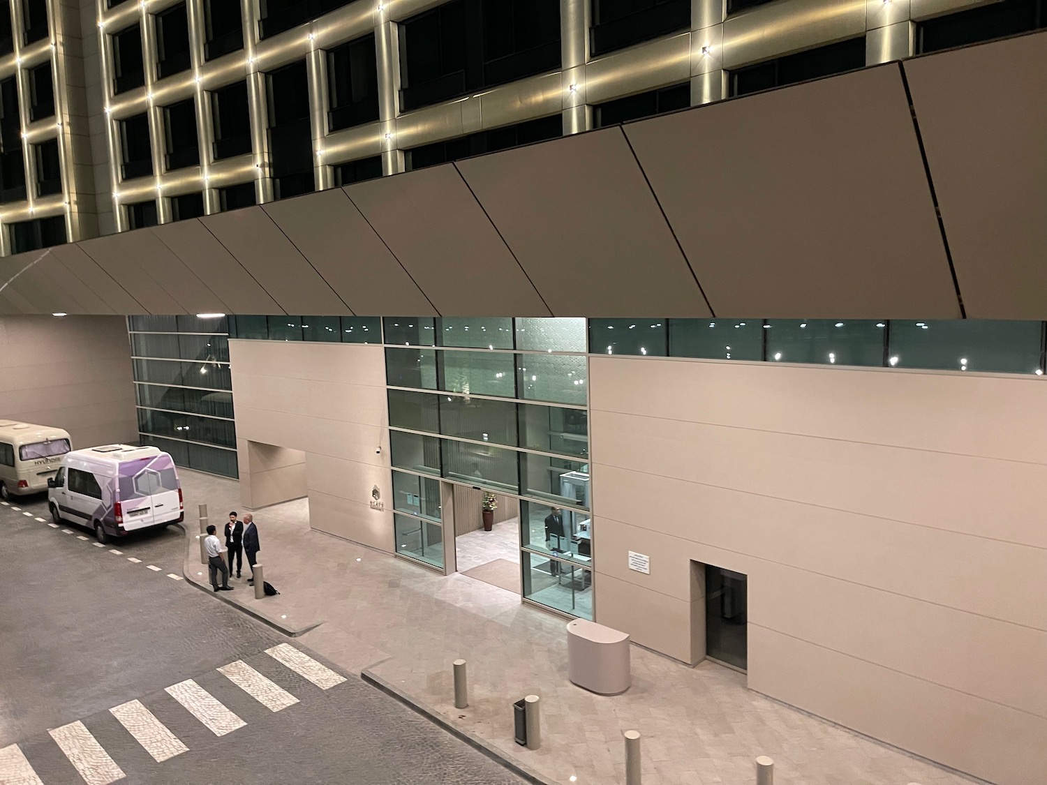 a building with a bus and people standing in front of it