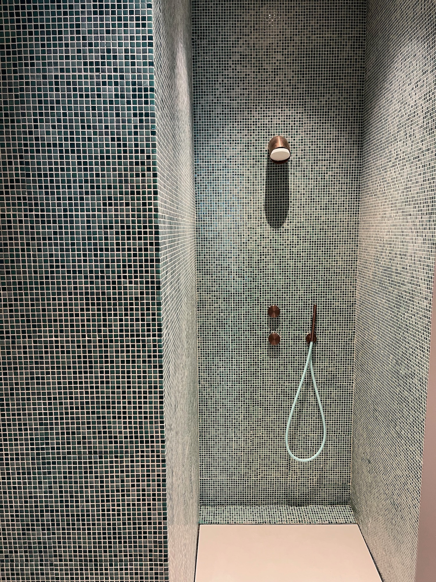 a shower with a shower head and a shower head