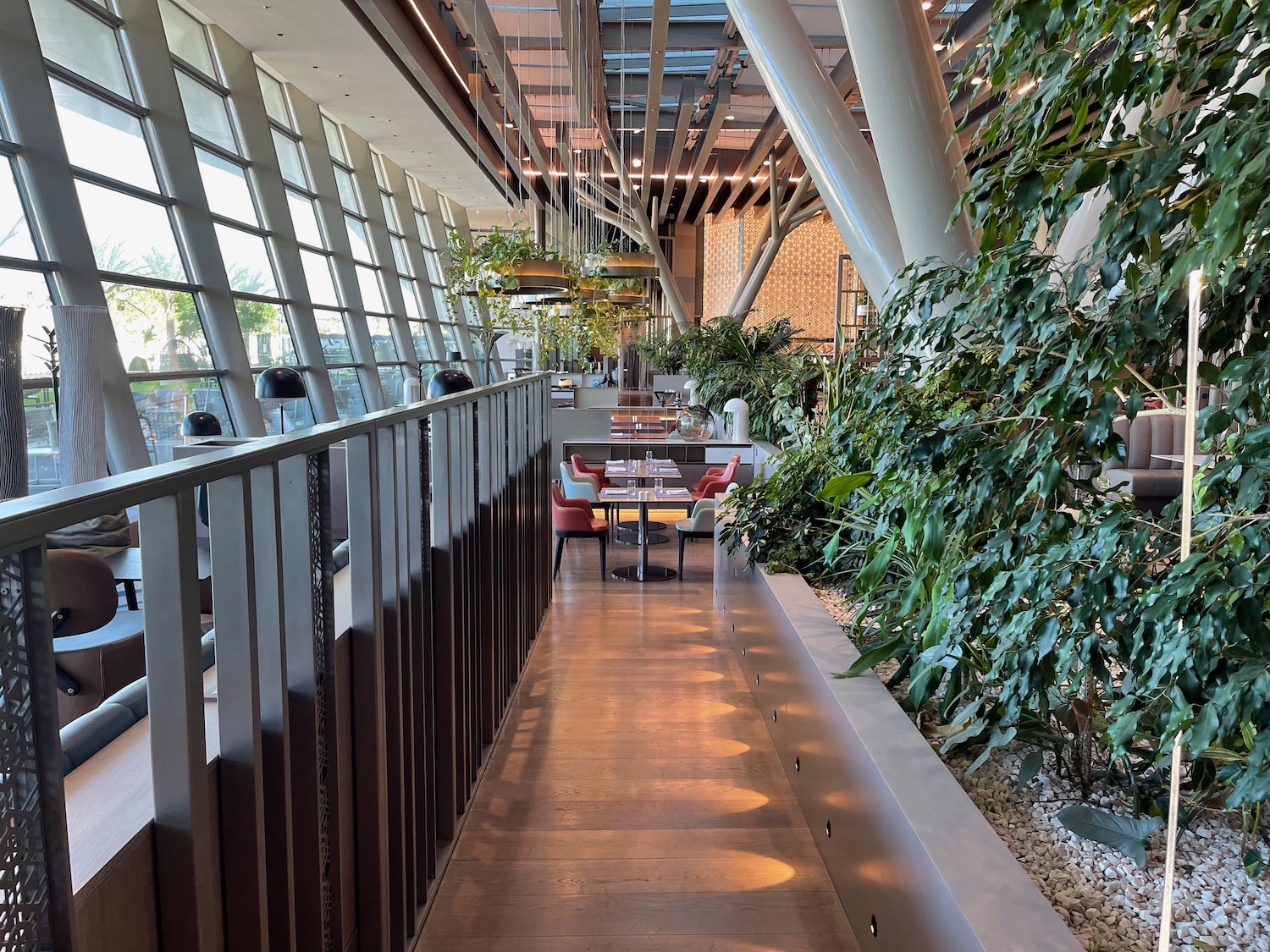 a long hallway with plants and tables