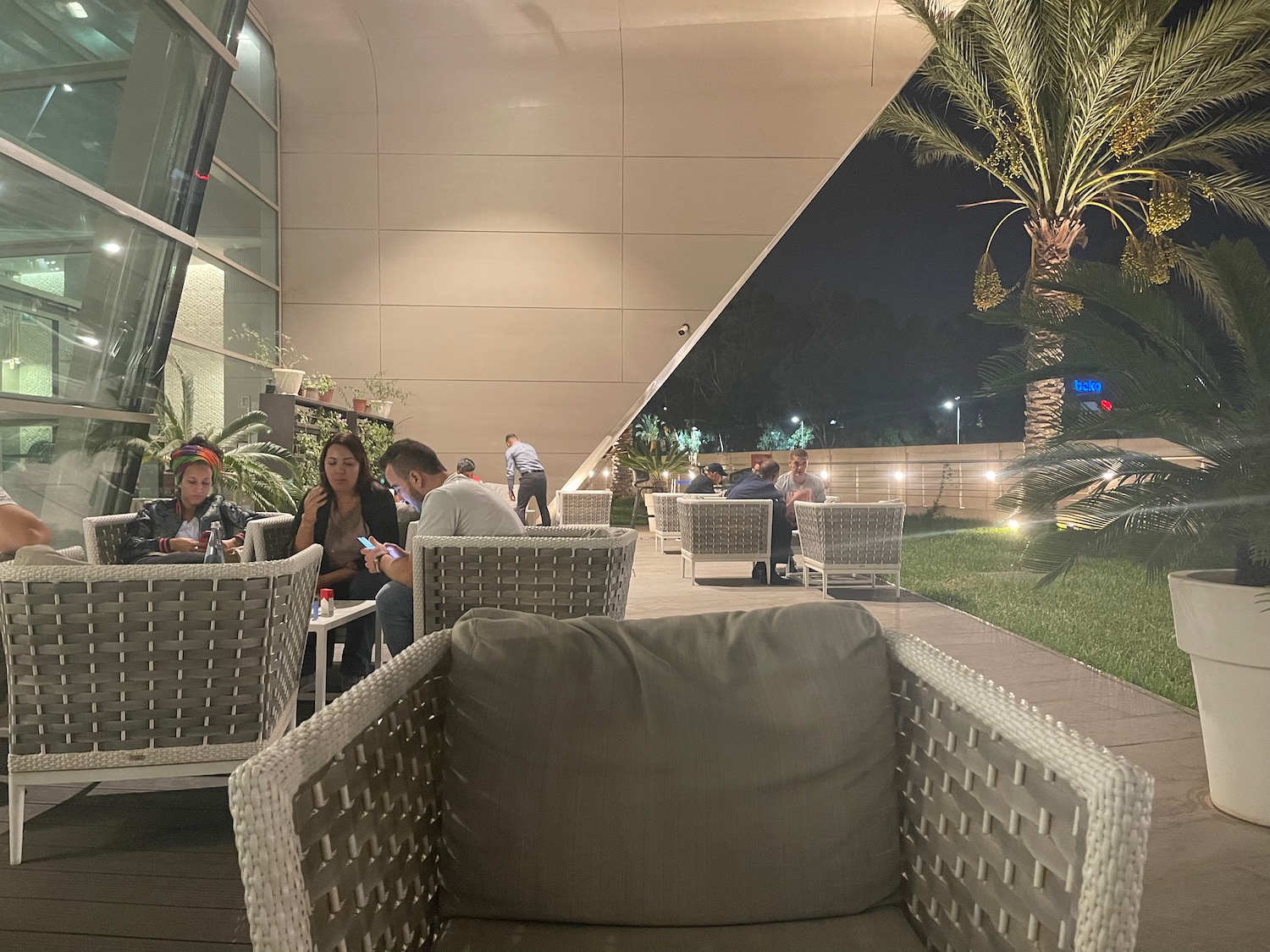 a group of people sitting at tables outside