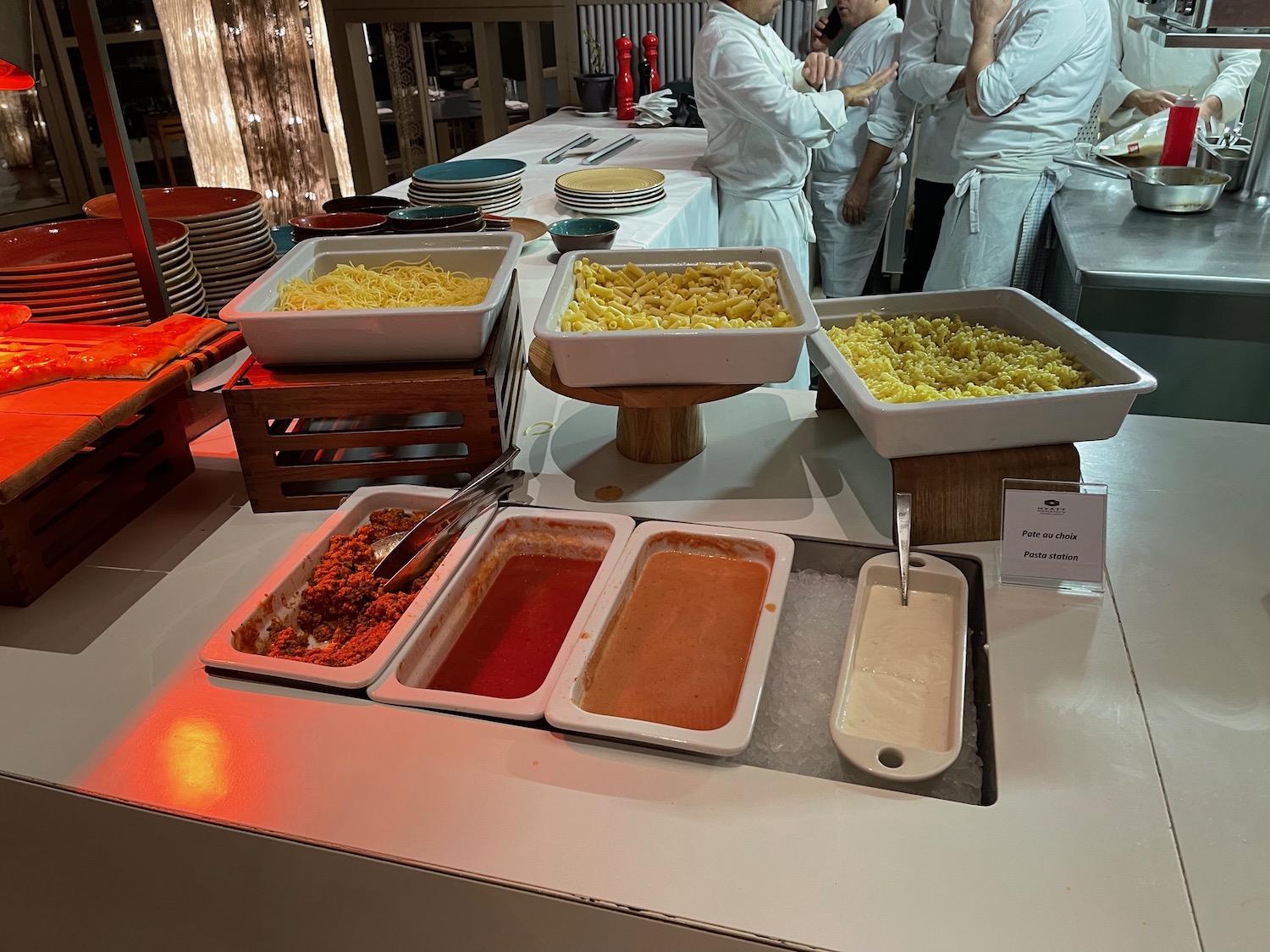 a group of people standing in front of a buffet table