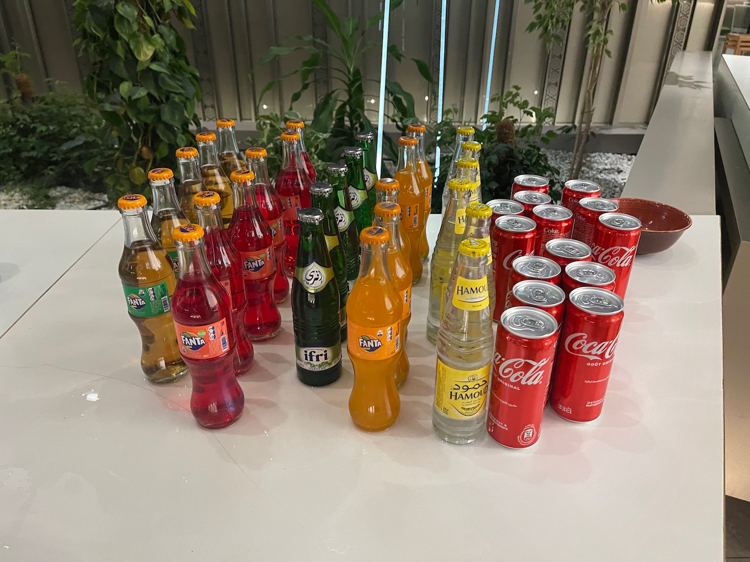 a group of soda bottles and cans on a table