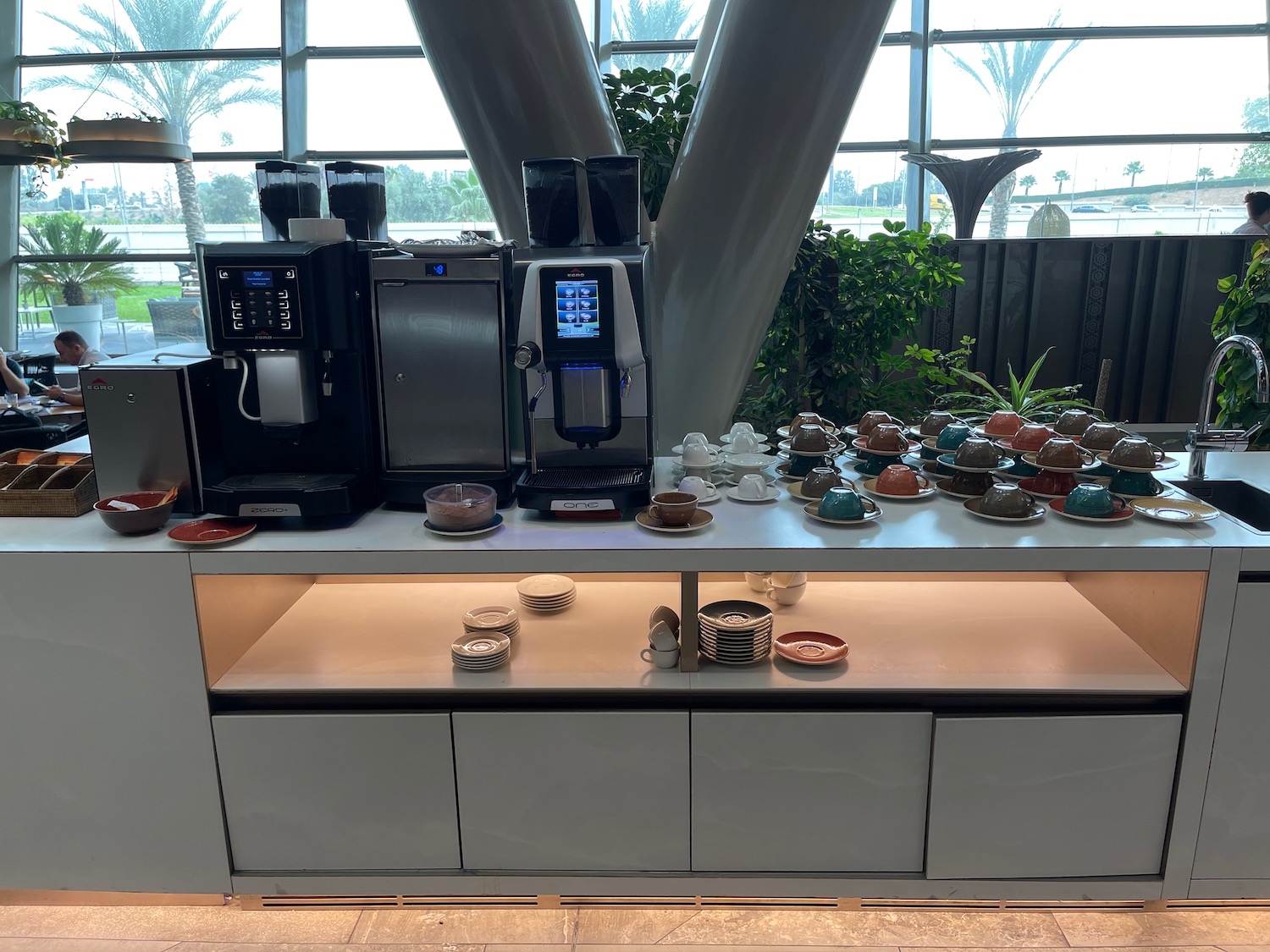 a coffee machine and tea cups on a counter