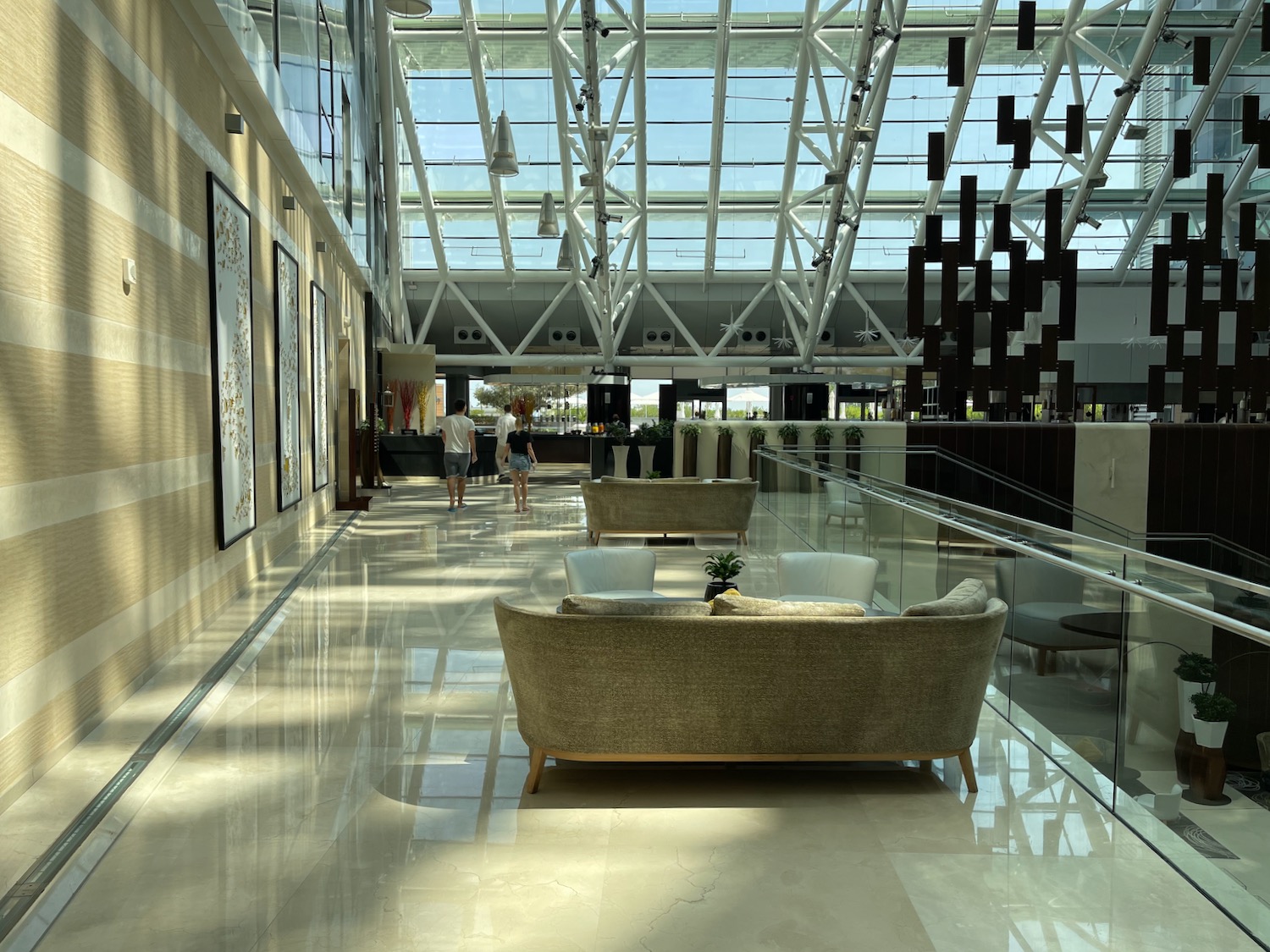 a large glass ceiling with a large sofa and chairs