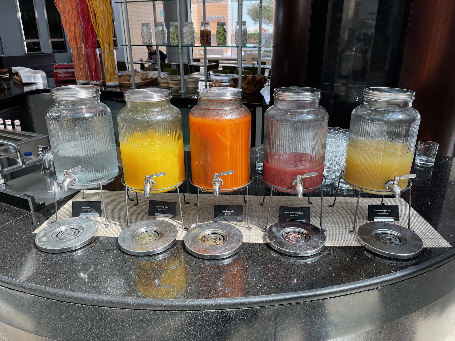 a row of glass jars with different colored liquid on a table