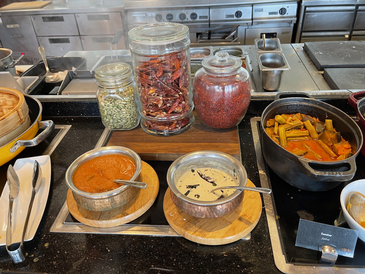 a kitchen with pots of food and containers of spices