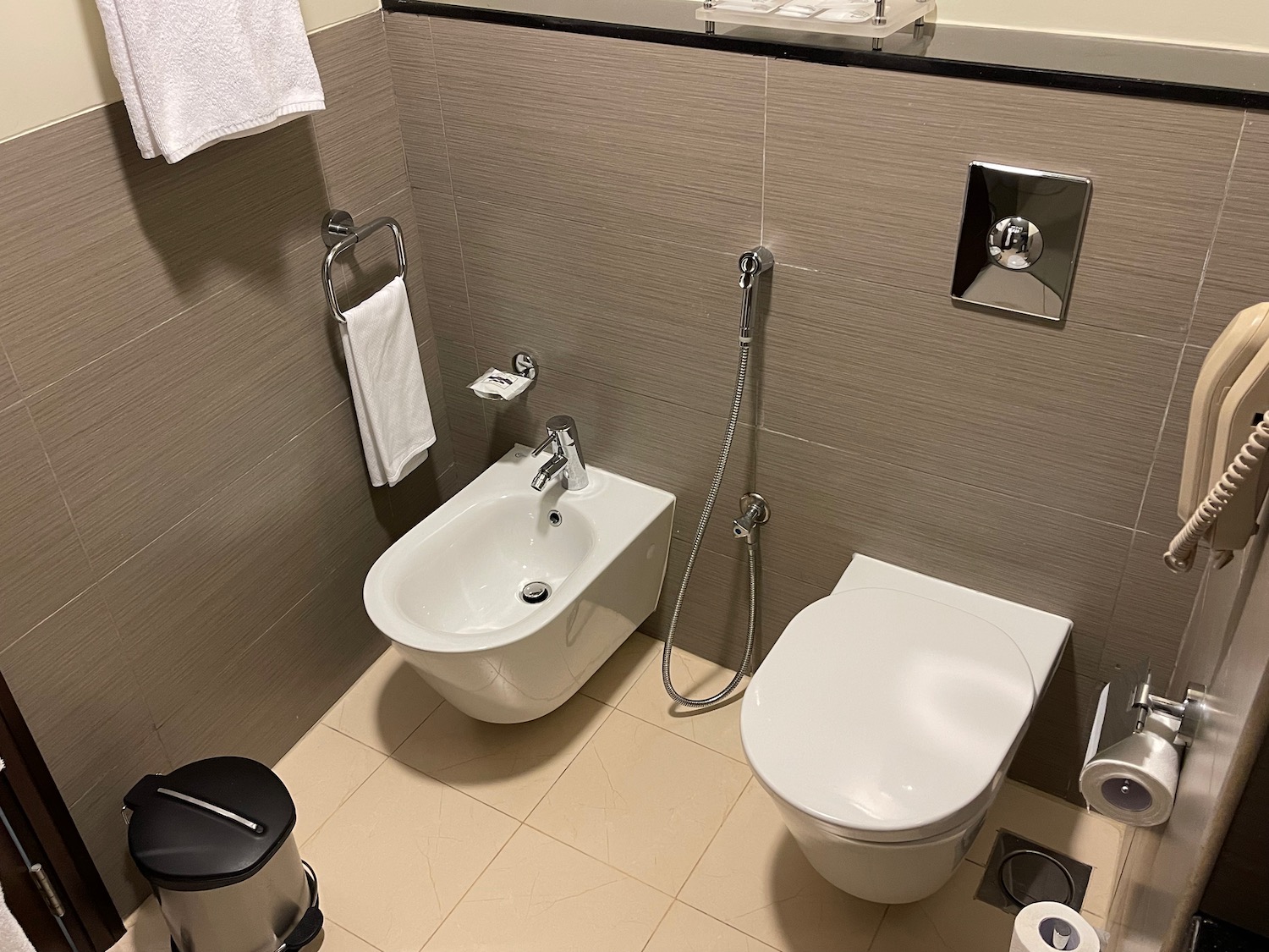 a bathroom with a bidet and toilet