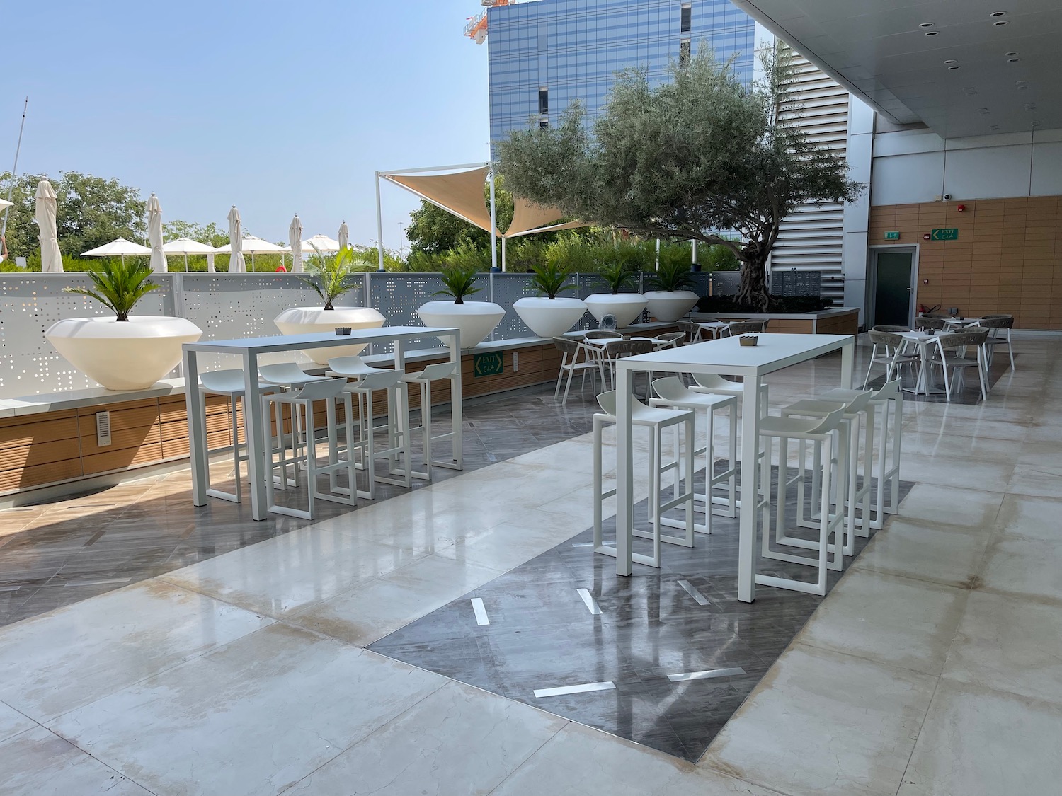 a patio with tables and chairs