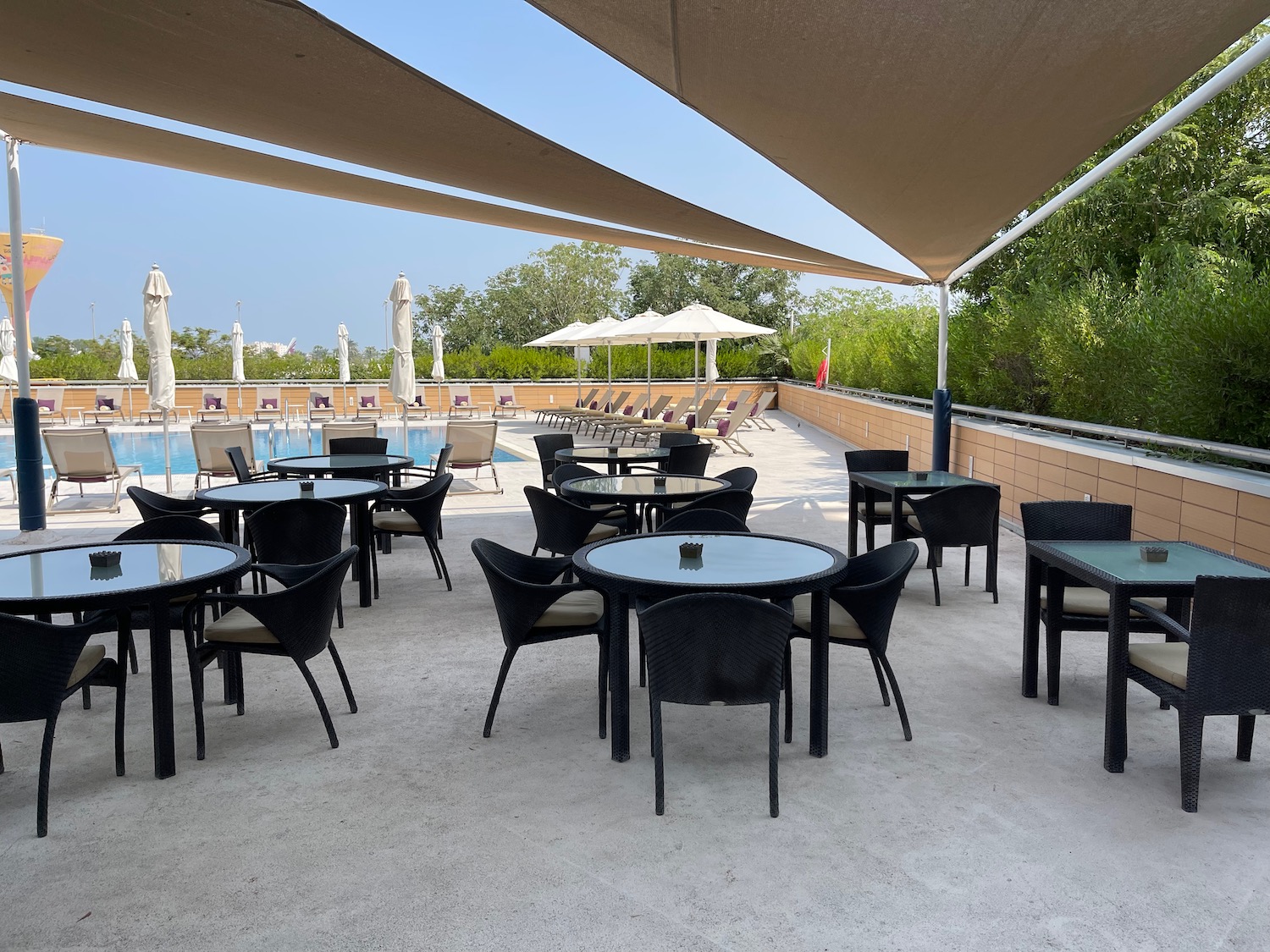 a patio with tables and chairs