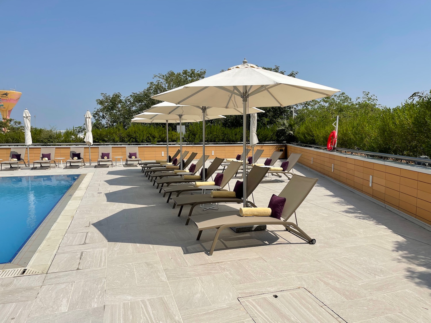 a pool with lounge chairs and umbrellas