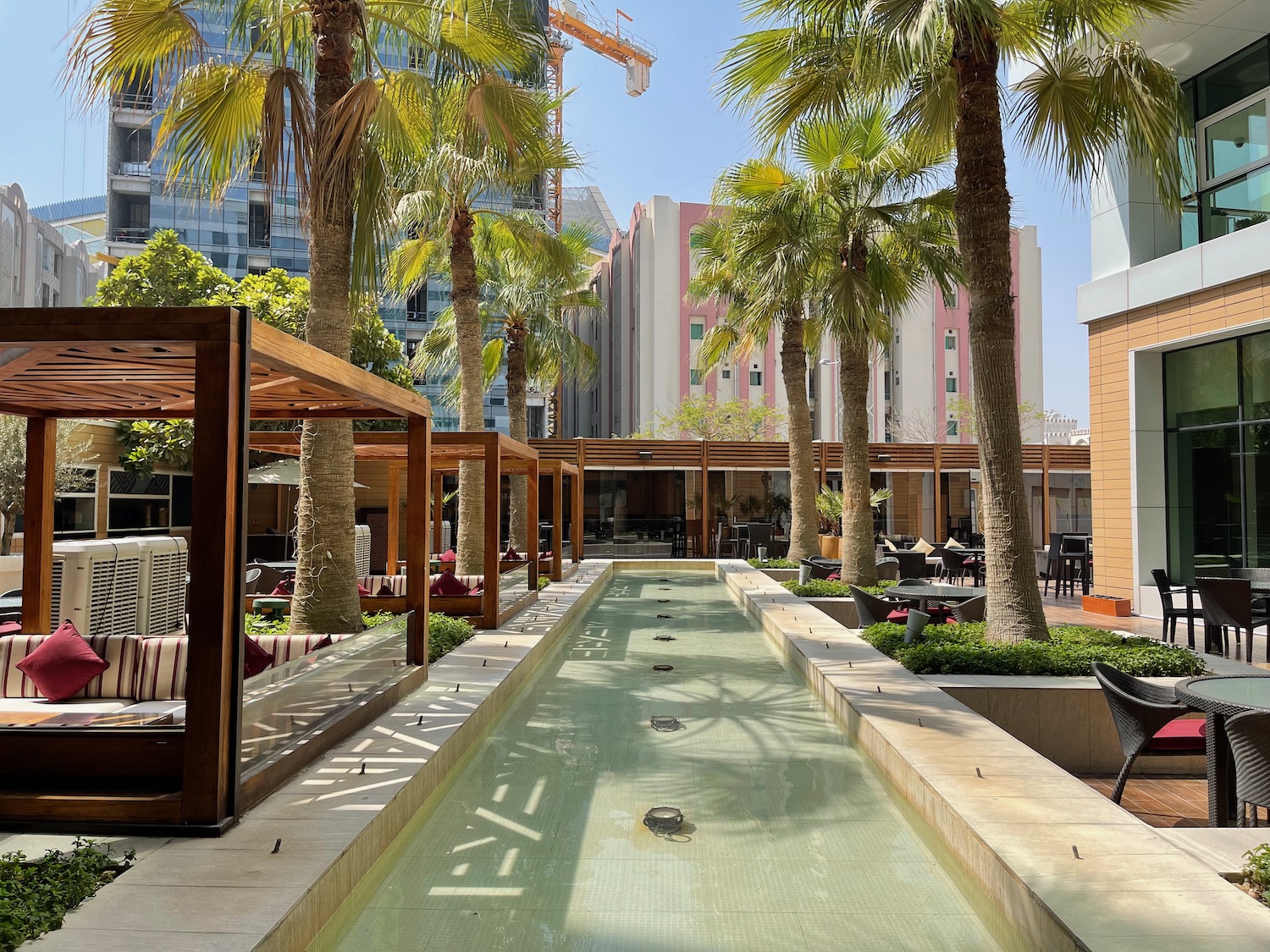 a water way with trees and a building in the background