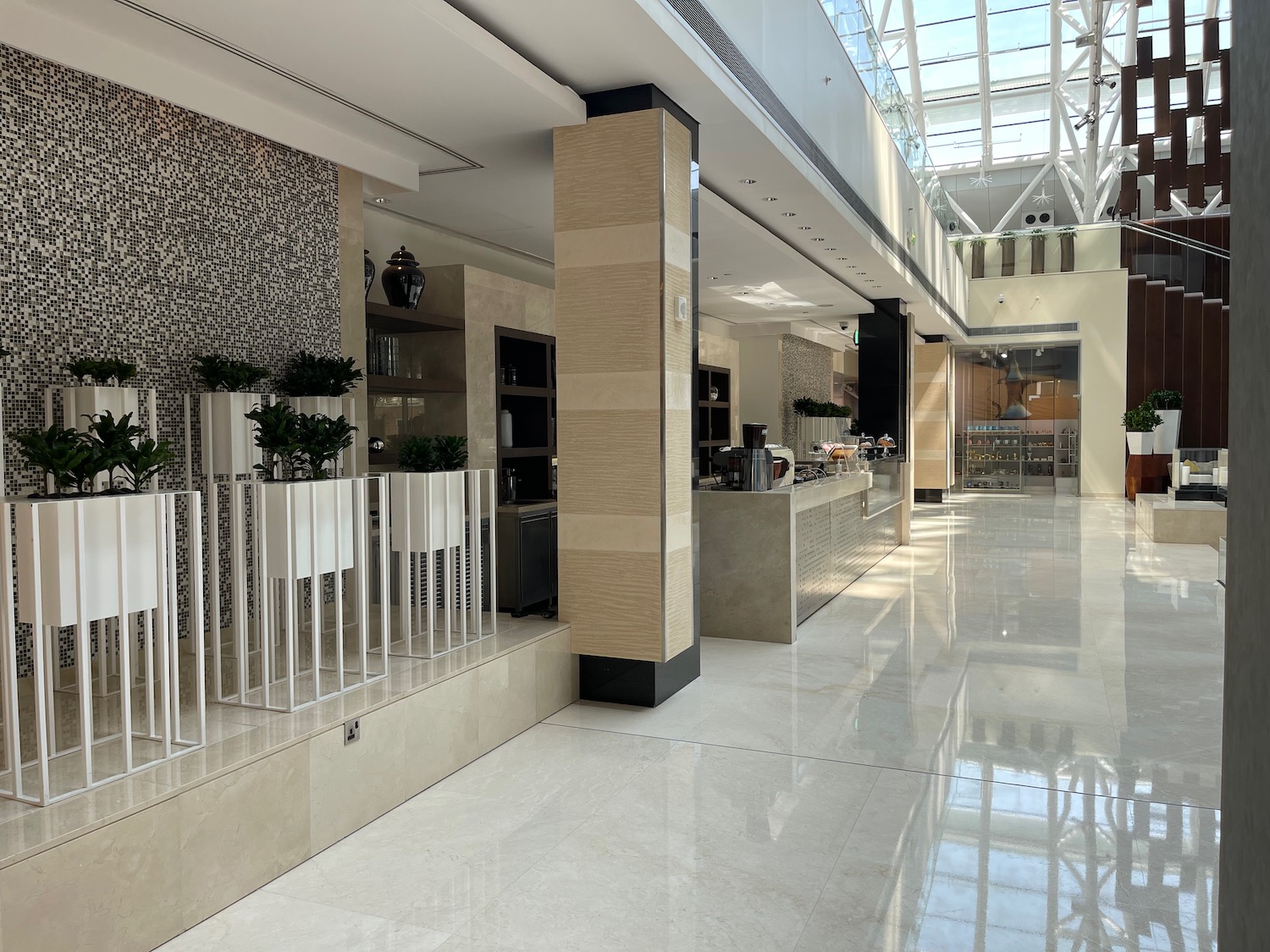 a large white and tan building with glass ceiling