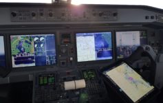 a cockpit of an airplane with multiple screens