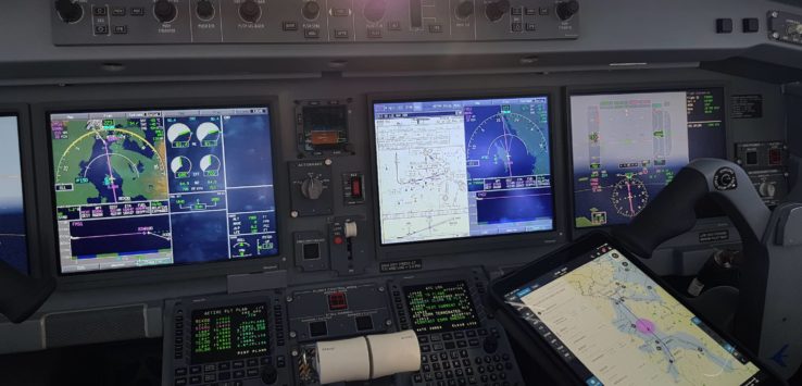 a cockpit of an airplane with multiple screens