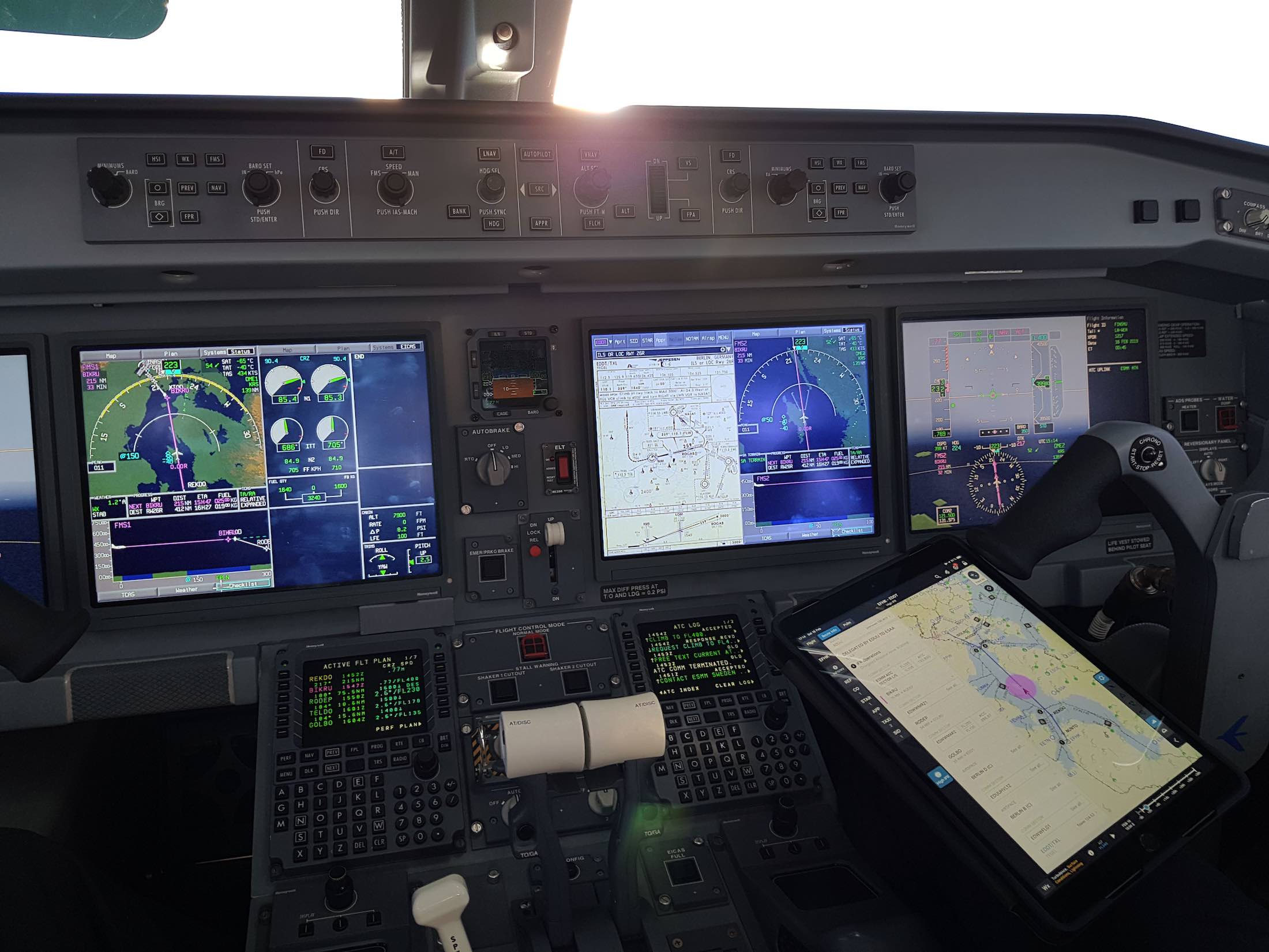 a cockpit of an airplane with multiple screens