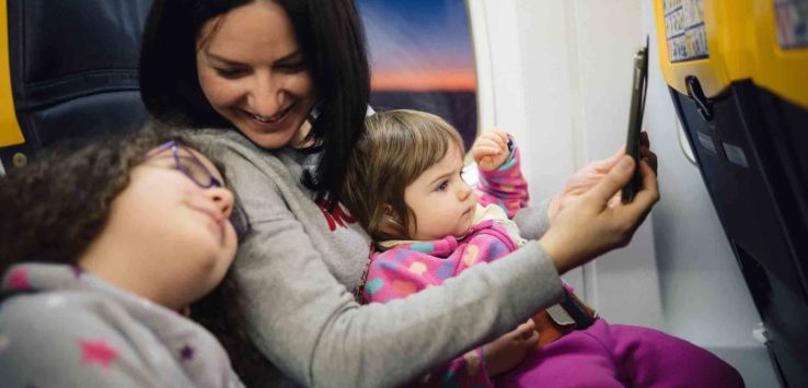 a woman and two children on a plane