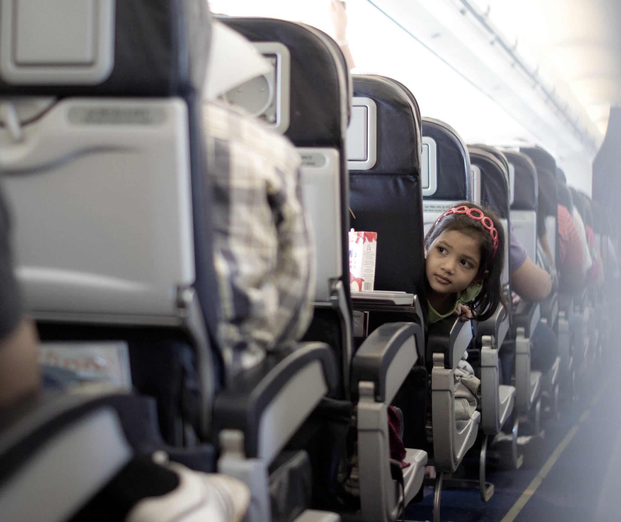 a child sitting in an airplane seat