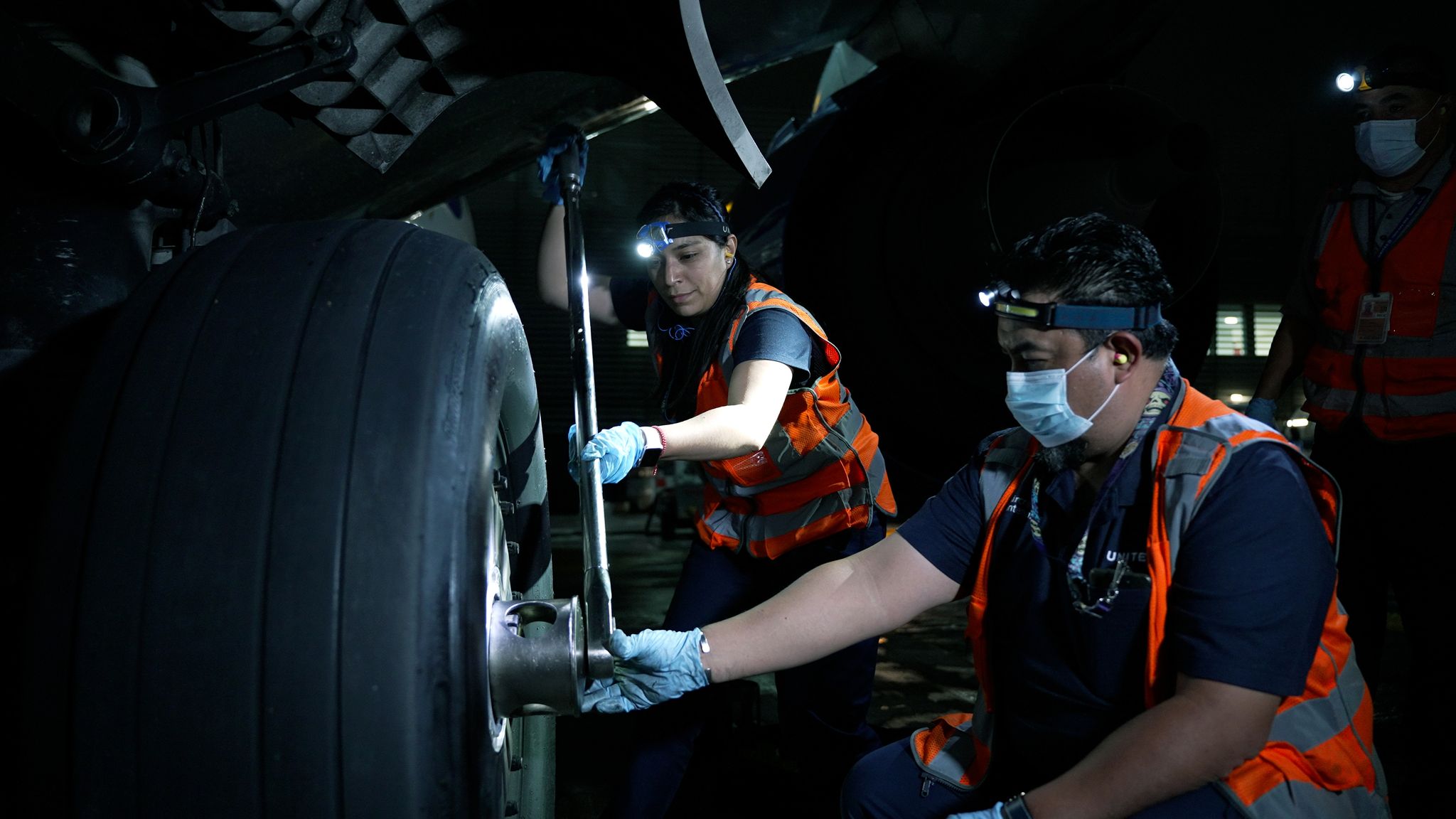 a group of people working on a car