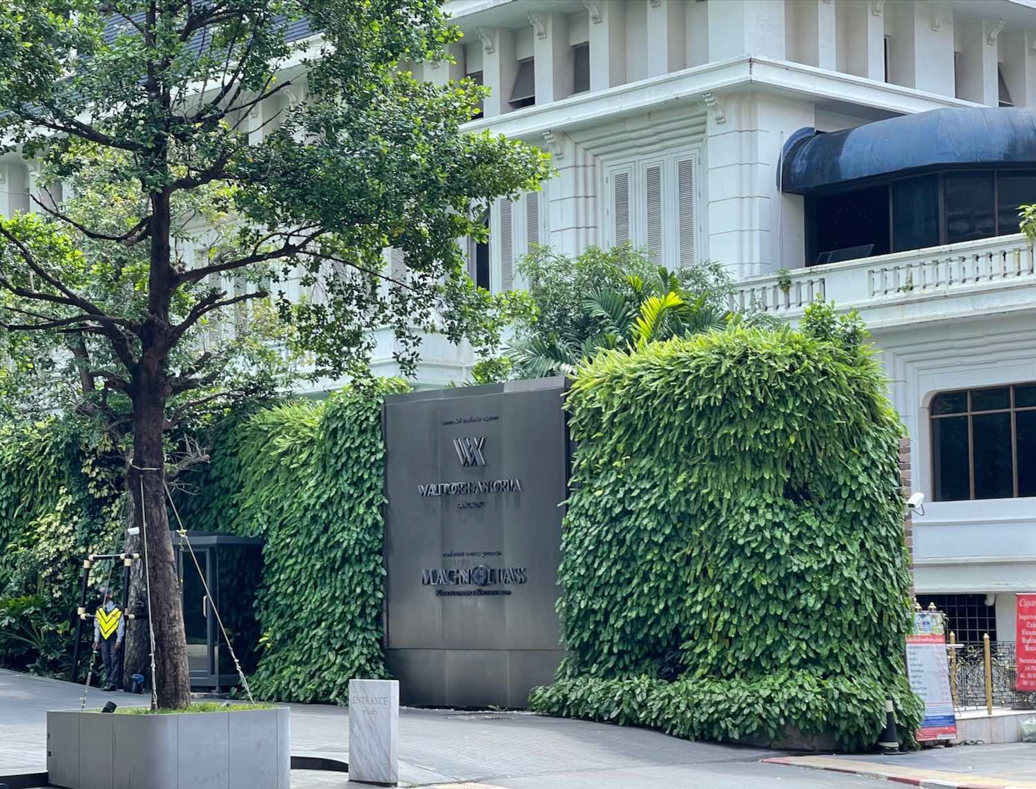 a building with a sign and trees